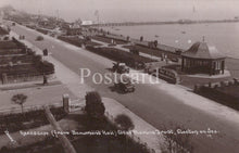 Load image into Gallery viewer, Vintage black and white postcard of a coastal scene with roads, buildings, and vehicles.

