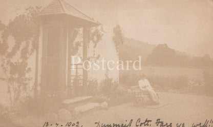 Vintage sepia-toned postcard with a gazebo and landscape