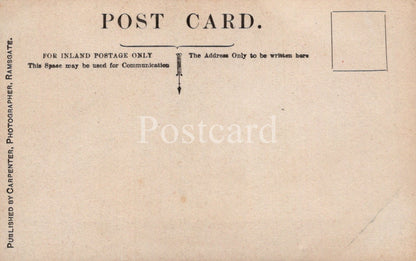 Back of a vintage postcard with text and a stamp