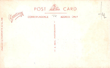 Back of a vintage postcard with red text on a yellowed paper background