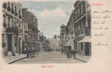 Load image into Gallery viewer, Vintage postcard of a street scene in Guildford, featuring buildings and people on a street.

