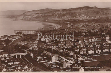 Vintage black and white postcard of Colwyn Bay from Bryn Eirth, showing coastal view with buildings and sea.
