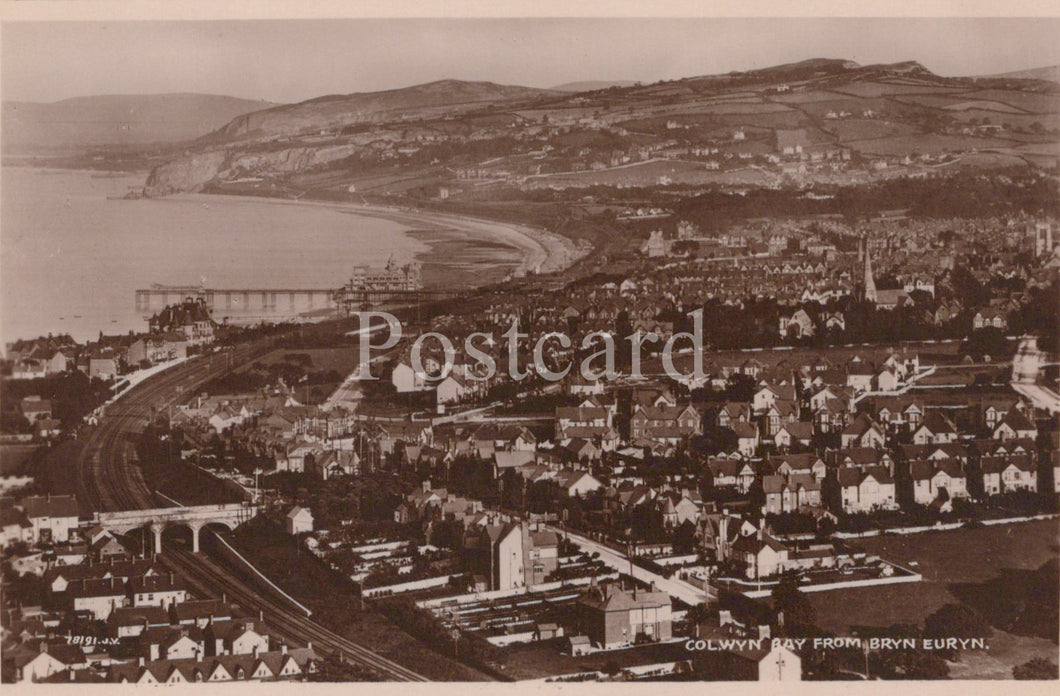 Vintage black and white postcard of Colwyn Bay from Bryn Eirth, showing coastal view with buildings and sea.