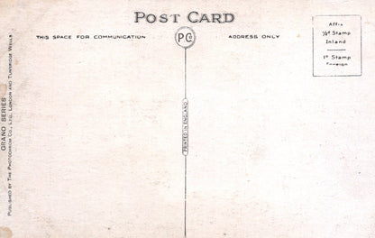 Back of a vintage postcard with printed text and stamps.