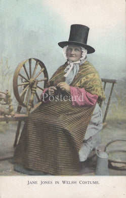 Woman in Welsh costume sitting with a spinning wheel, vintage postcard.