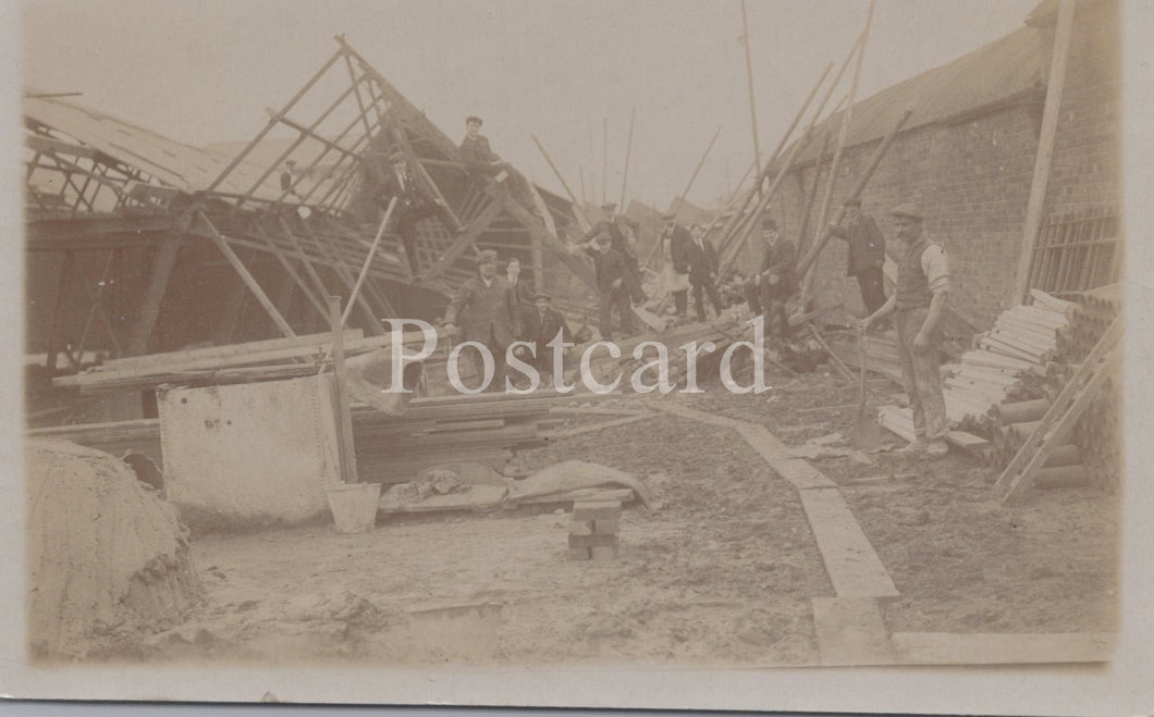 Vintage black and white photograph of a shipwreck with people around it, labeled 'Postcard'.