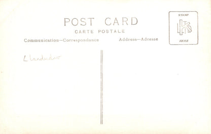 Vintage-style postcard with text and a stamp placeholder on a light background