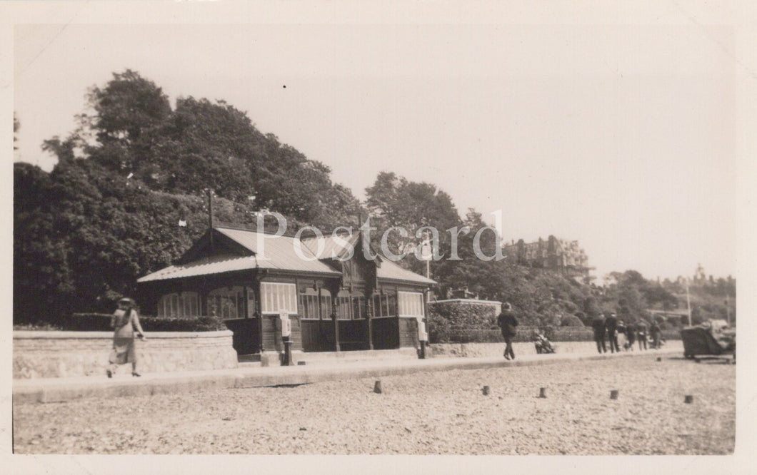 Vintage black and white photo of a building with people around, likely from a postcard.