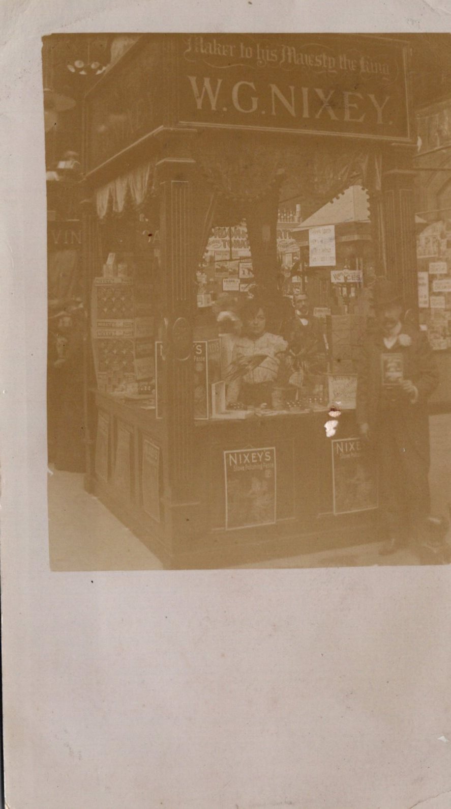 Vintage photograph of a store front with 'W.G. Nixey' branding.