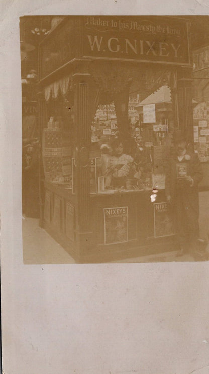 Vintage photograph of a store front with 'W.G. Nixey' branding.