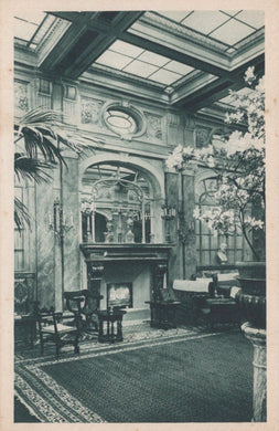 Vintage interior of a grand room with decorative ceiling, fireplace, and furniture.