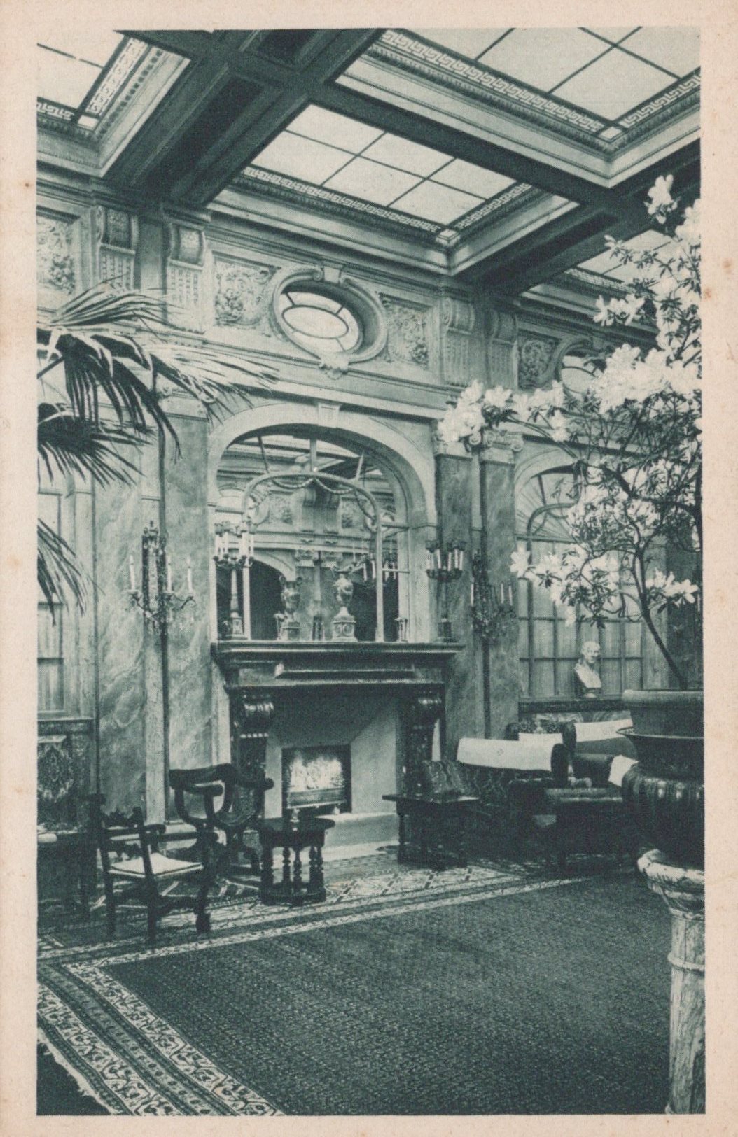 Vintage interior of a grand room with decorative ceiling, fireplace, and furniture.