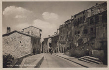 Load image into Gallery viewer, Vintage black and white photo of a street in a small town with stone buildings.
