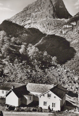 Vintage black and white photo of houses nestled in a mountainous landscape
