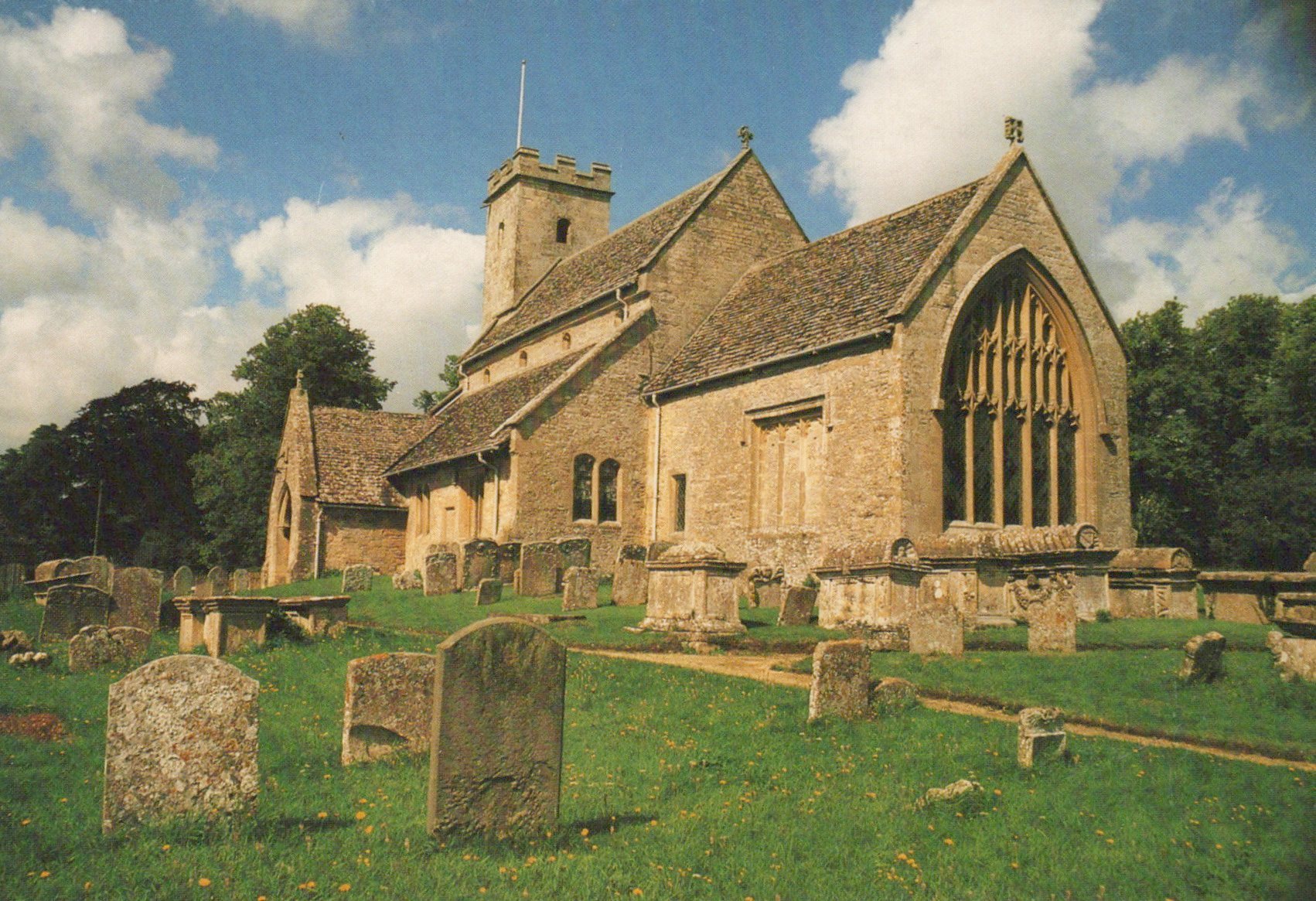 Stone church with a graveyard in a rural setting