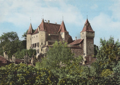 Castle surrounded by trees under a blue sky