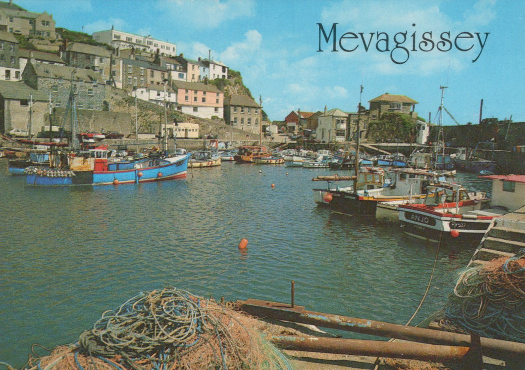 Harbor scene with boats and buildings in Mevagissey, Cornwall.