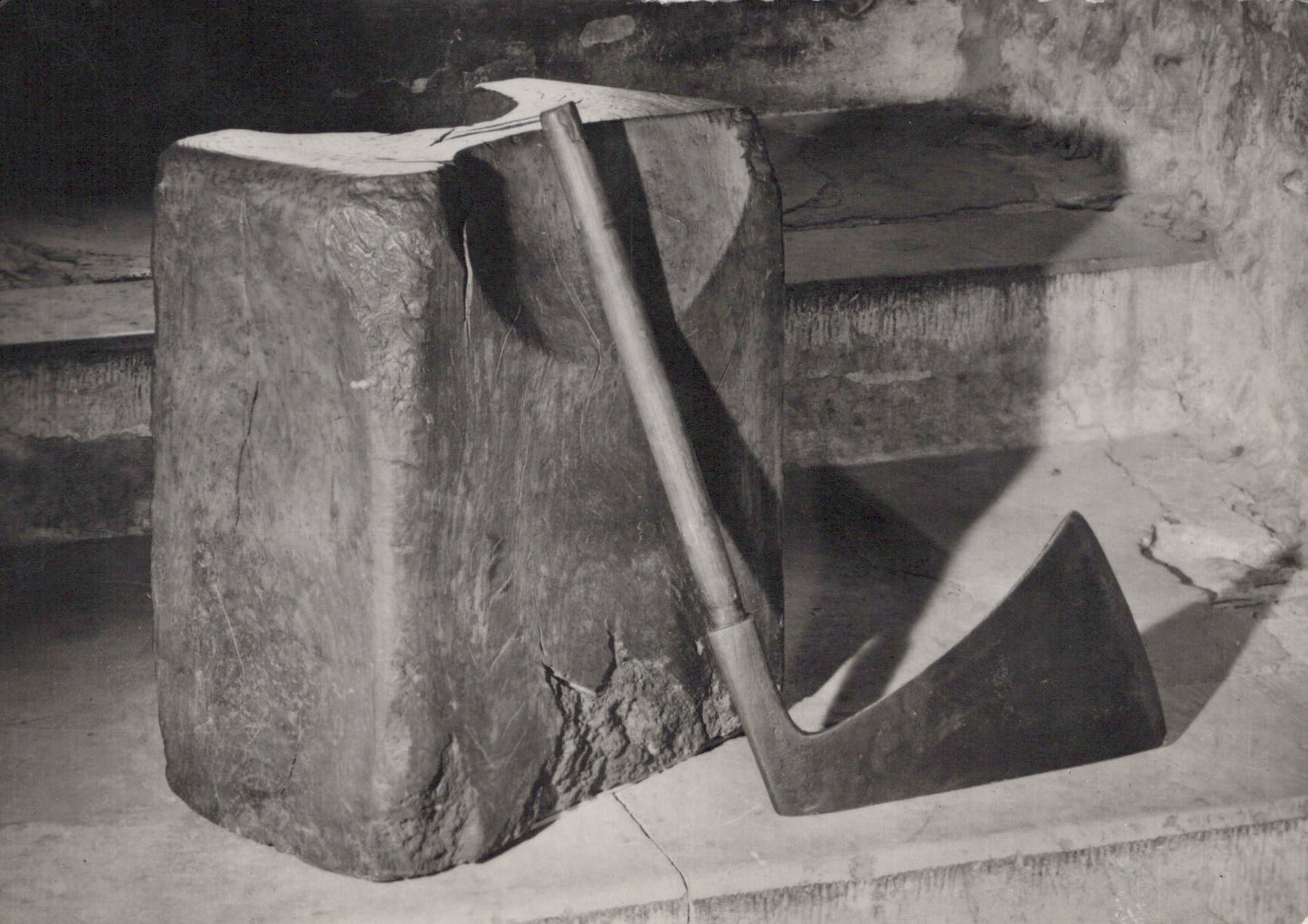 Abstract sculpture made of stone or concrete with a geometric design.