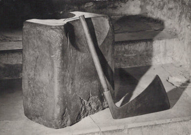 Abstract sculpture made of stone or concrete with a geometric design.