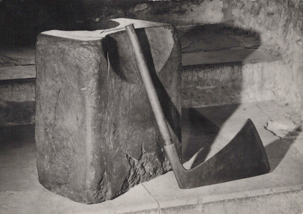 Abstract sculpture made of stone or concrete with a geometric design.