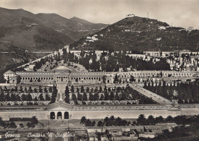 Vintage black and white photograph of a large cemetery with mountains in the background