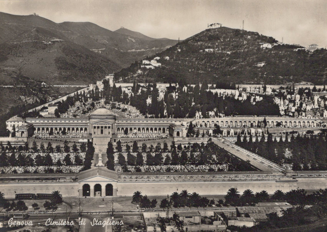 Vintage black and white photograph of a large cemetery with mountains in the background