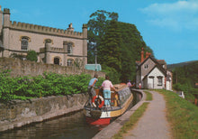Load image into Gallery viewer, Barge on a canal with a castle-like building and trees in the background

