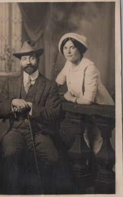 Vintage black and white photograph of a man and woman sitting together.