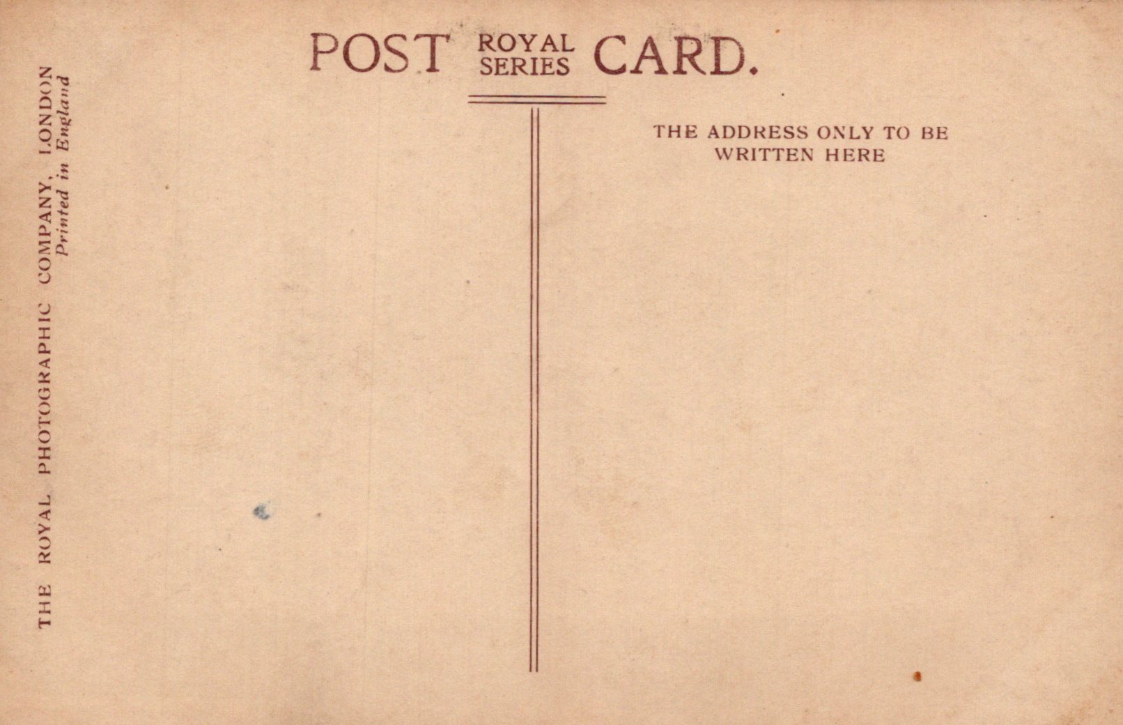 Back of a vintage postcard with text and a vertical line for writing the address.