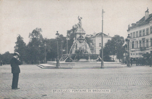 Vintage photograph of a man taking a photo of a fountain in Brussels, Belgium.
