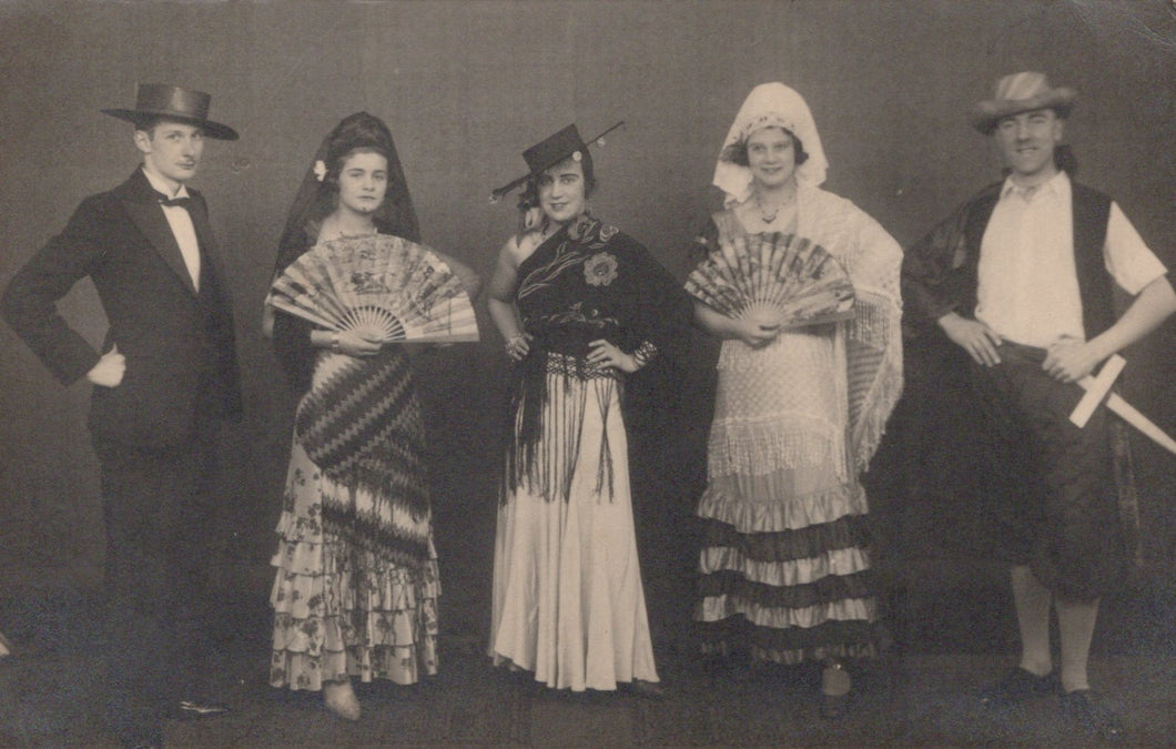 Group of people in traditional costumes posing for a photograph