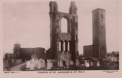 Ruins of St. Andrews and St. Rule Towers with gravestones in a cemetery.