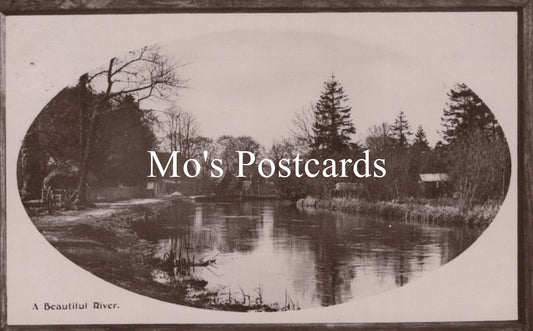 Vintage-style black and white photo of a river with trees 