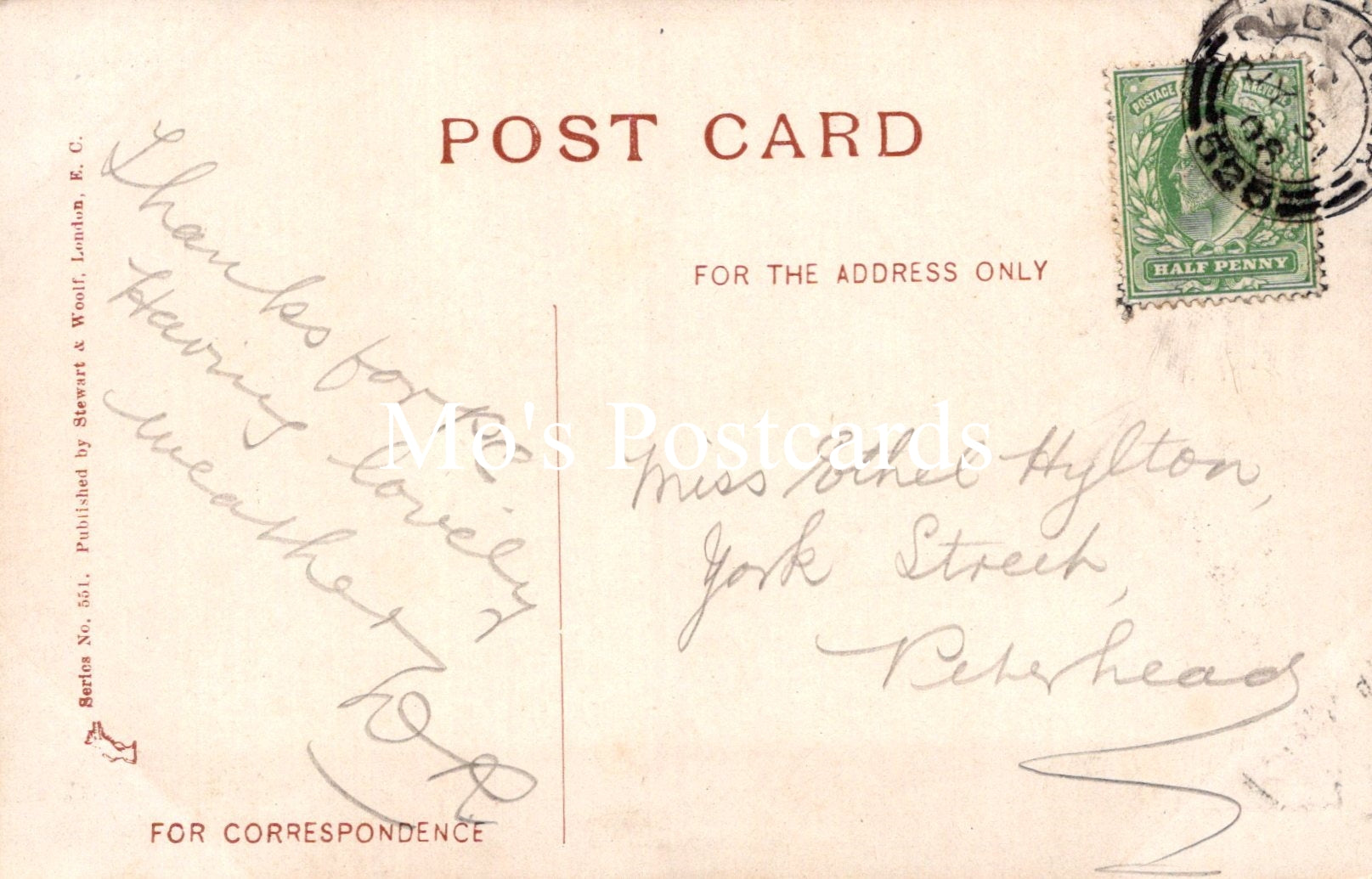 Vintage postcard with handwritten text and a stamp on a light brown background
