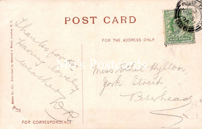 Vintage postcard with handwritten text and a stamp on a light brown background