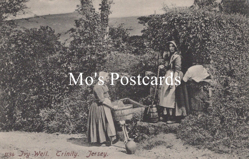 Vintage black and white postcard of two women in a garden.