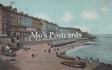 Load image into Gallery viewer, Vintage postcard of a coastal scene with buildings and people on a promenade.
