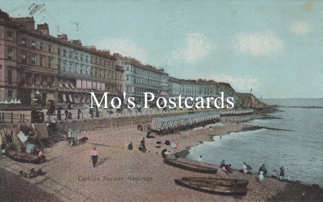 Vintage postcard of a coastal scene with buildings and people on a promenade.