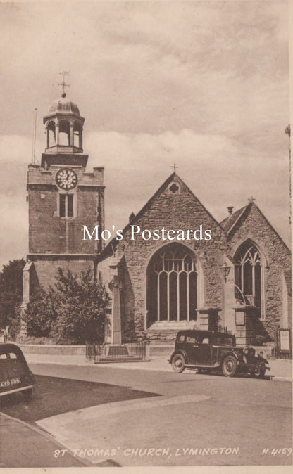 Vintage postcard of St. Thomas Church in Lymington with a clock tower and old car.