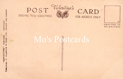 Vintage Valentine's Day postcard with text and a decorative heart design on a beige background.