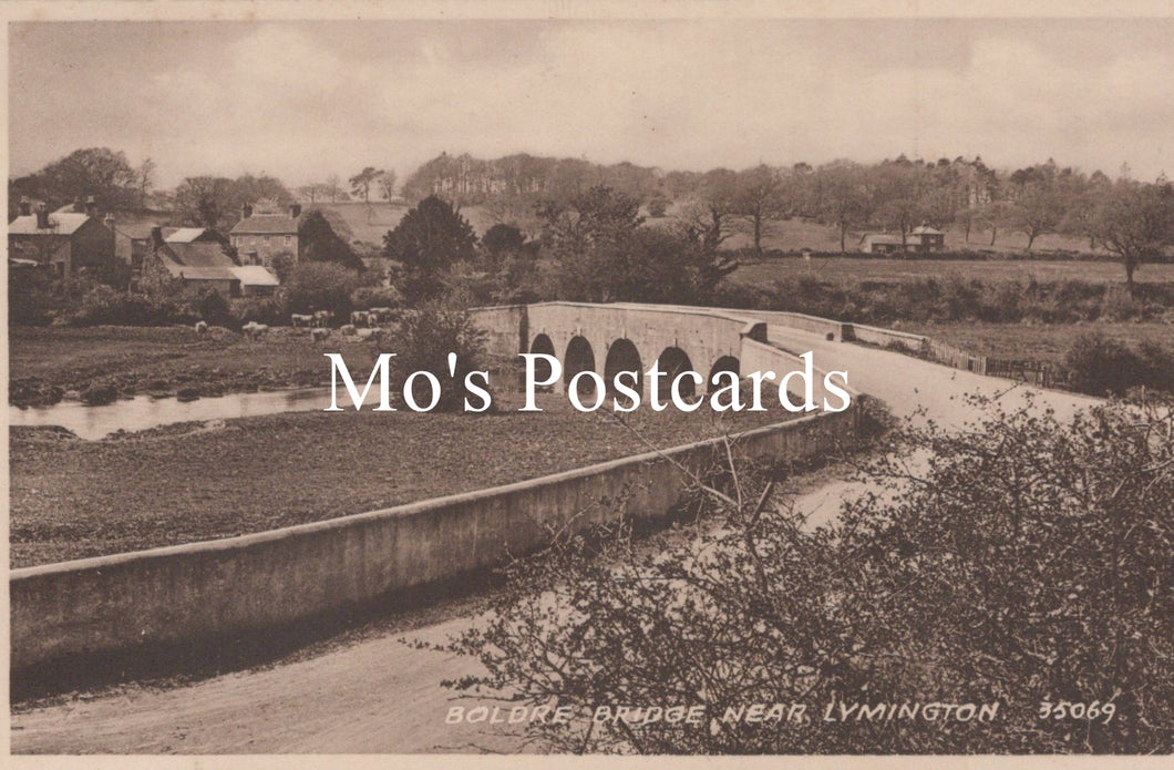 Vintage black and white postcard of a bridge over a river  