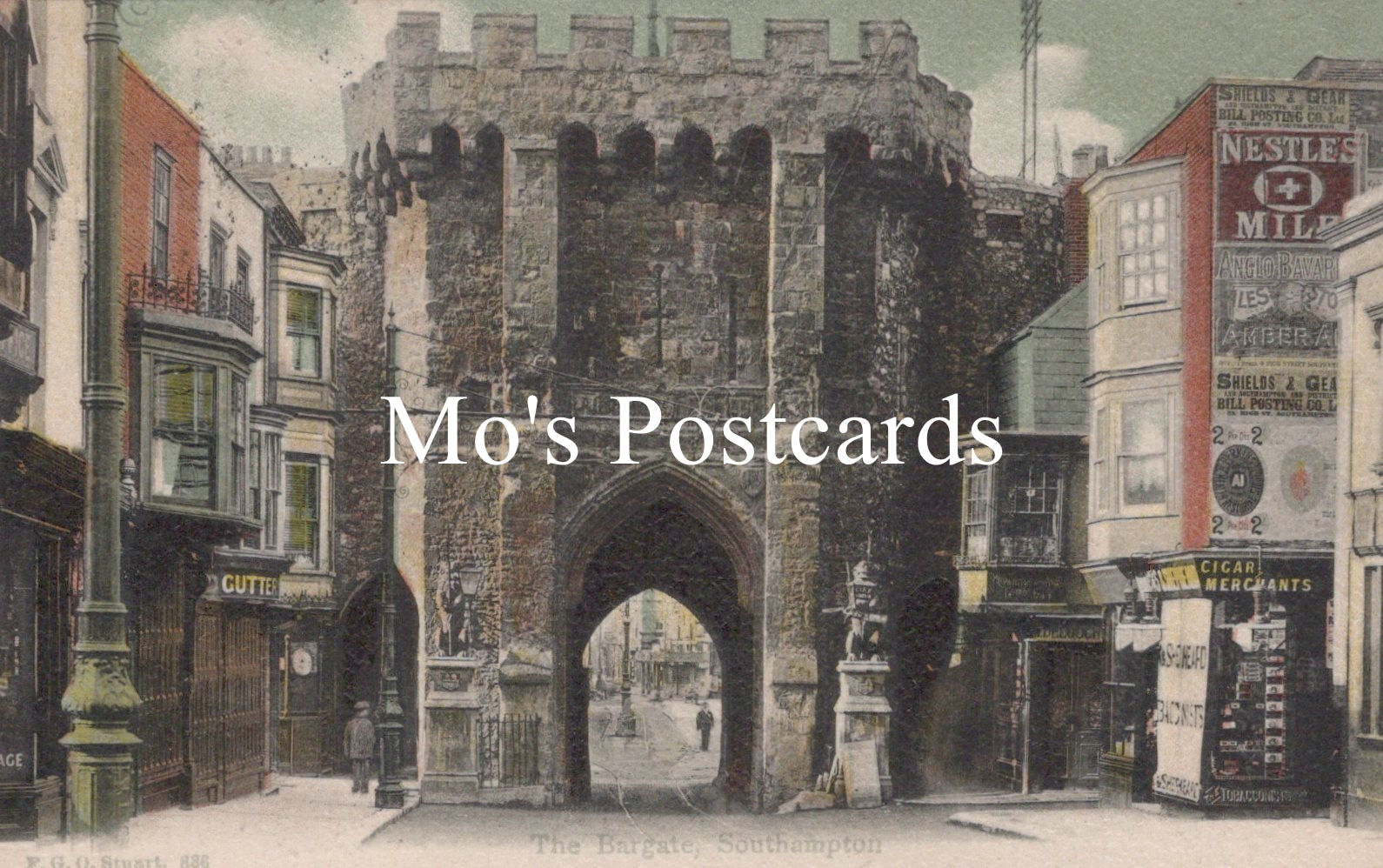 Vintage street scene with a large stone archway and colorful signs 