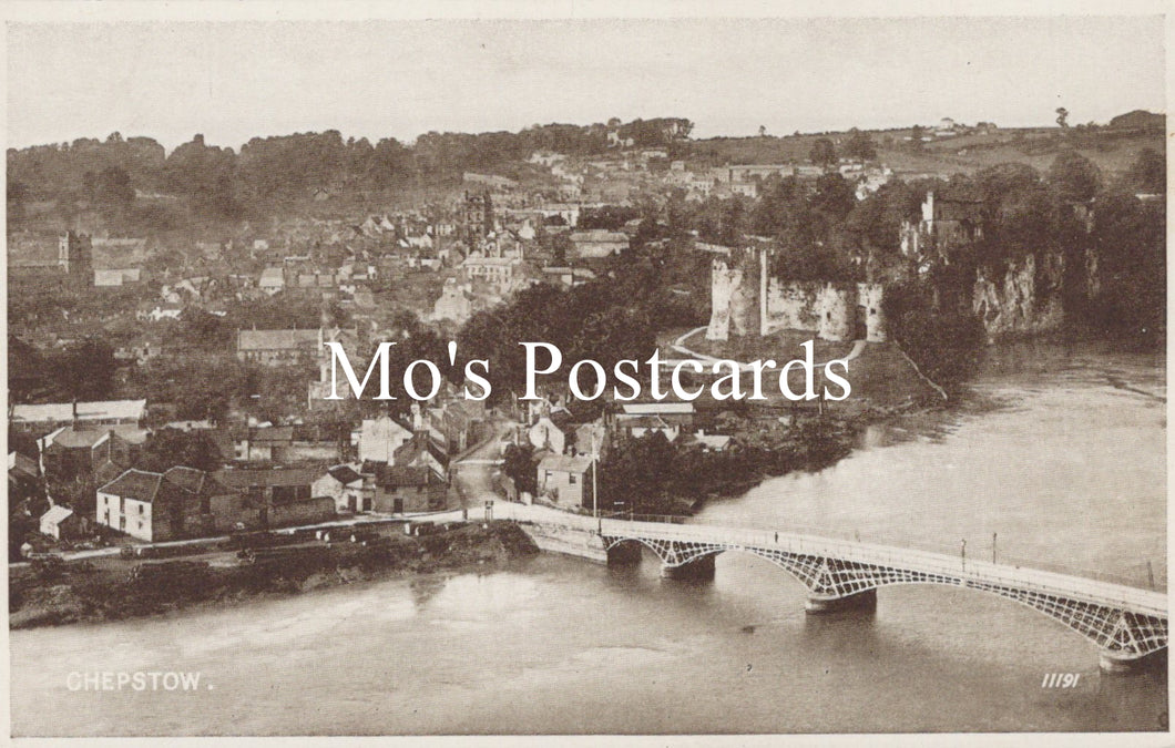 Vintage black and white postcard of a town with a bridge over water 