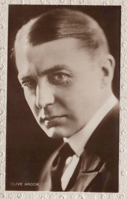 Vintage black and white portrait of Clive Brook with a decorative border.