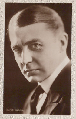 Vintage black and white portrait of Clive Brook with a decorative border.