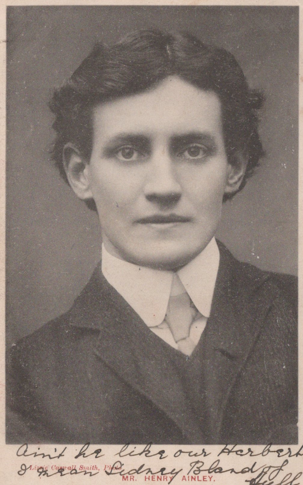 Black and white portrait of a young man in formal attire with text on the back.