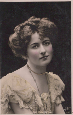 Vintage black and white portrait of a woman with styled hair and lace dress.