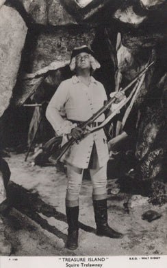 Black and white image of a character from 'Treasure Island' holding a rifle in a cave setting.