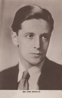 Vintage black and white portrait of a man wearing a suit and tie.