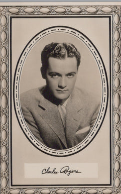 Vintage black and white portrait of a man in a suit with decorative frame and signature at the bottom.